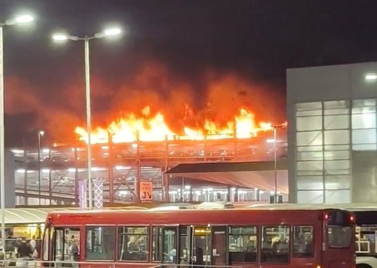 Screen grab taken with permission from video posted on Twitter by @Soriyn23of a fire at a car park at Luton Airport On Tuesday. All flights at the airport were suspended. Issue date: Wednesday October 11, 2023. Photo credit: @Soriyn23/PA Wire