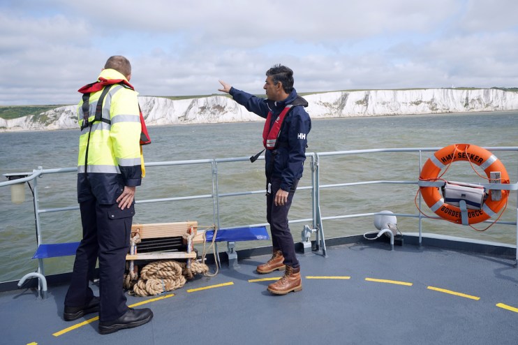 Prime Minister Rishi Sunak speaking with director of Small Boats Operational Command (SBOC) Duncan Capps (left), onboard Border Agency cutter HMC Seeker