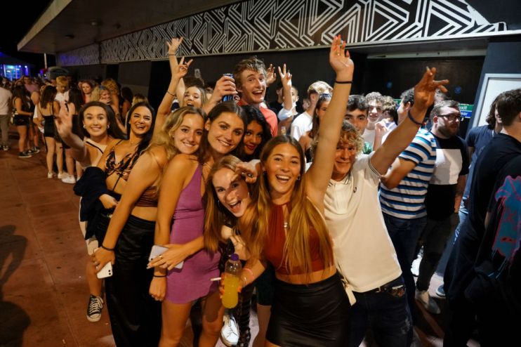 BRIGHTON, ENGLAND - JULY 18: Clubbers queue around the block at a few minutes to midnight waiting for Covid-19 restrictions to be dropped and for Pryzm nightclub to open its doors once more on July 18, 2021 in Brighton, England. At a minute past midnight, England dropped most of its remaining Covid-19 social restrictions, such as those requiring indoor mask-wearing and limits on group gatherings. These changes come despite rising infections, pitting the country's vaccination programme against the virus's more contagious Delta variant. (Photo by Chris Eades/Getty Images)