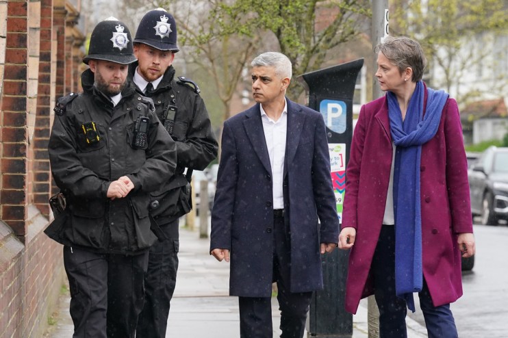 Sadiq Khan has been criticised for not delivering a planned &lsquo;track my crime&rsquo; portal. Pictured, Khan and Yvette Cooper with two Met Police officers. Photo: PA