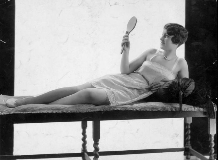 A woman looks into a mirror