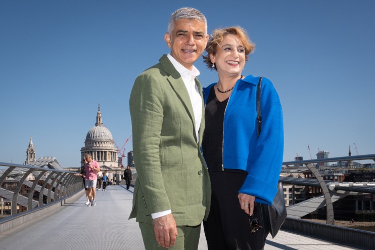 Sadiq Khan and his wife Saadiya walk across the Millennium Bridge. Photo: PA