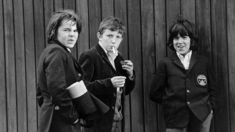 May 1972: Three secondary schoolboys smoking an illicit cigarette in Hyde Park, London. (Photo by Evening Standard/Getty Images)