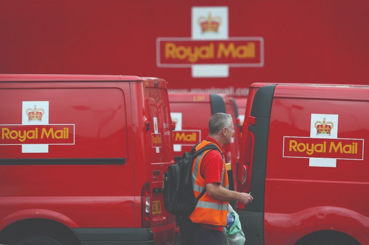 Royal Mail delivery van outside a postal depot, representing the &pound;21m fine by Ofcom for late mail deliveries.