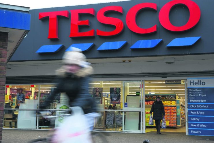 Tesco store exterior with festive decorations, highlighting its 10-year UK market share high and Q3 sales performance.