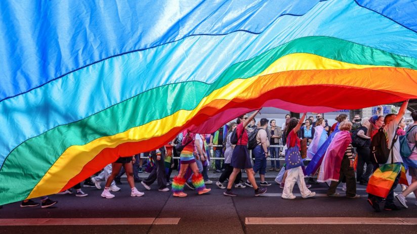 BERLIN, GERMANY - JULY 22: Participants hold a big pride rainbow flag during the annual Christopher Street Day parade on July 22, 2023 in Berlin, Germany. CSD Berlin is among Europe's biggest Pride events and is a demonstration and celebration of the rights of LGBTQIA+ people. (Photo by Omer Messinger/Getty Images)