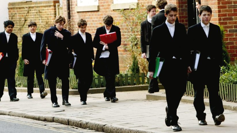 ETON, ENGLAND - MARCH 1: Pupils at Eton College hurry between lessons, March 1, 2004 wearing the school uniform of tailcoats and starched collars, in Eton, England. Dozens of the country's foremost independent schools are facing heavy fines if a government inquiry finds them guilty of operating a fee-fixing cartel. (Photo by Graeme Robertson/Getty Images)