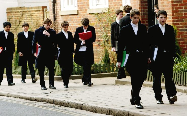 ETON, ENGLAND - MARCH 1: Pupils at Eton College hurry between lessons, March 1, 2004 wearing the school uniform of tailcoats and starched collars, in Eton, England. Dozens of the country's foremost independent schools are facing heavy fines if a government inquiry finds them guilty of operating a fee-fixing cartel. (Photo by Graeme Robertson/Getty Images)