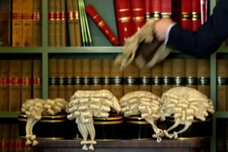British barristers wigs symbolizing legal tradition amidst rising class action lawsuits affecting UK economy