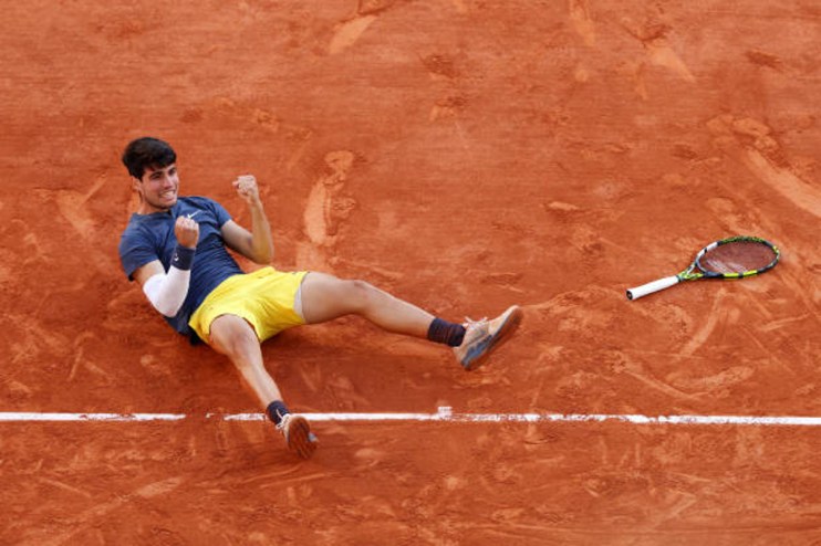 Carlos Alcaraz moved to within one title of a career Grand Slam on Sunday with a marathon five set victory over Alexander Zverev at the French Open.