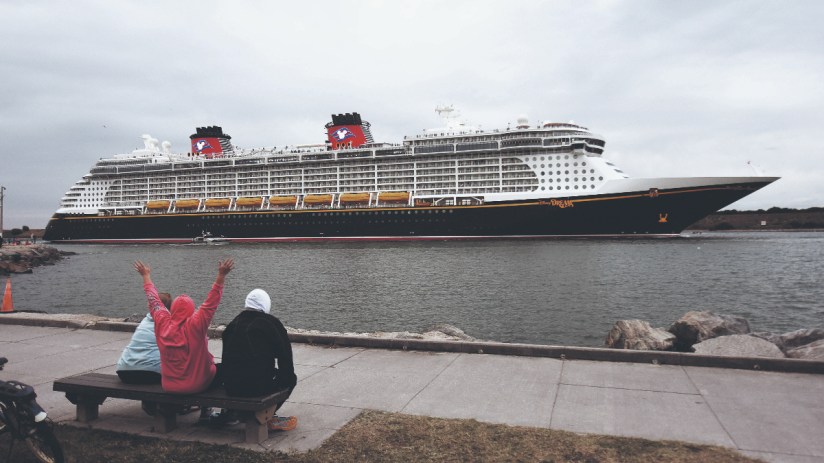 PORT CANAVERAL, FLORIDA, UNITED STATES - 2022/01/28: A person held his hands up as the Disney Dream cruise ship departs from Port Canaveral. (Photo by Paul Hennessy/SOPA Images/LightRocket via Getty Images)