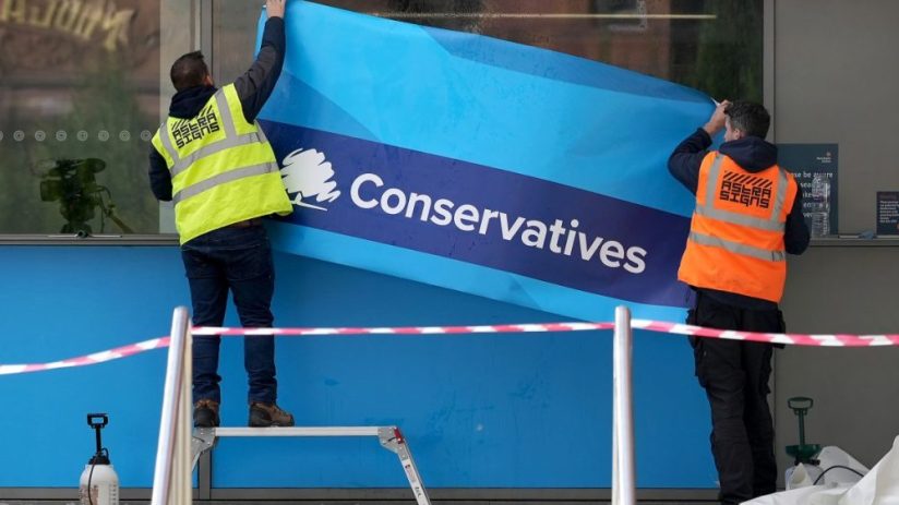 MANCHESTER, ENGLAND - OCTOBER 01: Workers erect Conservative Party branding on the windows of Manchester Central ahead of the Conservative party conference on October 01, 2021 in Manchester, England. The Conservative conference takes place between 3rd&ndash;6th October. (Photo by Christopher Furlong/Getty Images)