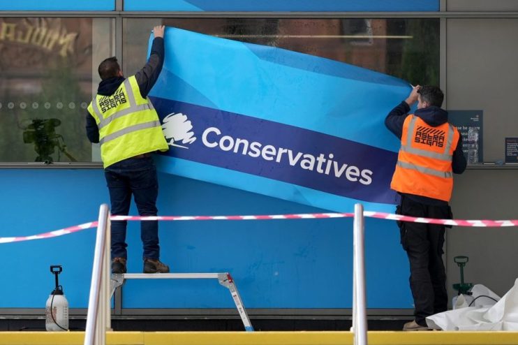 MANCHESTER, ENGLAND - OCTOBER 01: Workers erect Conservative Party branding on the windows of Manchester Central ahead of the Conservative party conference on October 01, 2021 in Manchester, England. The Conservative conference takes place between 3rd&ndash;6th October. (Photo by Christopher Furlong/Getty Images)