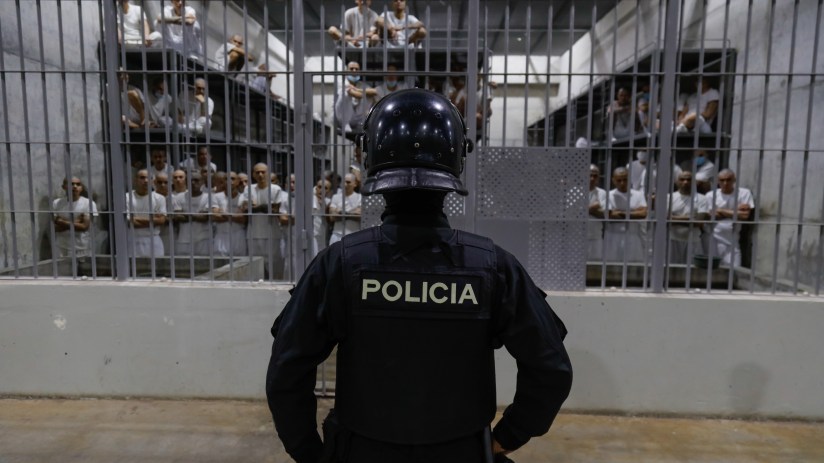 An officer in riot gear stands on patrol inside a cell at CECOT in Tecoluca on February 6, 2024 in San Vicente, El Salvador. On February of 2023 El Salvador inaugurated Latin America's largest prison as part of President Nayib Bukele's plan to fight gangs. Since then, the UN and NGOs have raised concern about the treatment of inmates, minors being held and suspects incarcerated as gang members without sufficient proof. Meanwhile, Bukele claims El Salvador's murder rate has fallen from the world's highest to the lowest in the Western Hemisphere. (Photo by Alex Pe&ntilde;a/Getty Images)