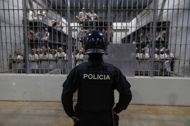 An officer in riot gear stands on patrol inside a cell at CECOT in Tecoluca on February 6, 2024 in San Vicente, El Salvador. On February of 2023 El Salvador inaugurated Latin America's largest prison as part of President Nayib Bukele's plan to fight gangs. Since then, the UN and NGOs have raised concern about the treatment of inmates, minors being held and suspects incarcerated as gang members without sufficient proof. Meanwhile, Bukele claims El Salvador's murder rate has fallen from the world's highest to the lowest in the Western Hemisphere. (Photo by Alex Pe&ntilde;a/Getty Images)
