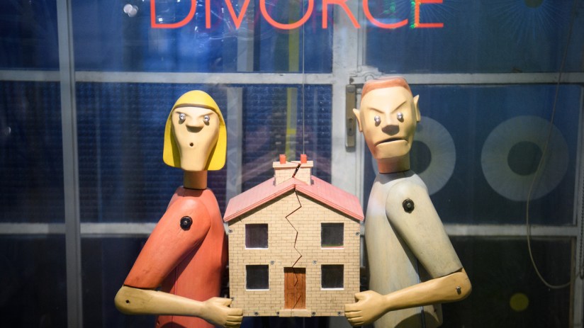 Angry couple splitting a house representing divorce