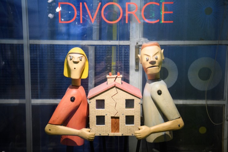 Angry couple splitting a house representing divorce