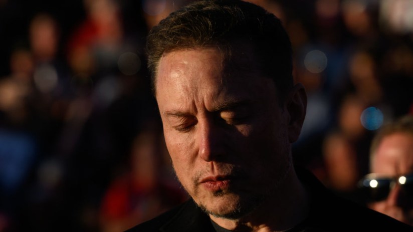 Elon Musk, chief executive officer of Tesla Inc., closes his eyes for a moment of silence, during a campaign rally for former president Donald Trump. Photographer: Justin Merriman/Bloomberg via Getty Images
