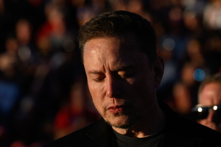 Elon Musk, chief executive officer of Tesla Inc., closes his eyes for a moment of silence, during a campaign rally for former president Donald Trump. Photographer: Justin Merriman/Bloomberg via Getty Images
