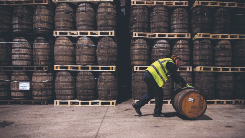 Workers fill casks that will be stored at the distillery for a minimum of three years before the product can be called Scotch Whisky at the whisky Annandale Distillery, in Annan, in Dumfries and Galloway, in Scotland. (Photo by Andy Buchanan / AFP) (Photo by ANDY BUCHANAN/AFP via Getty Images)