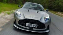 Aston Martin headquarters with company logo, highlighting job cuts and financial struggles amid tariff impacts