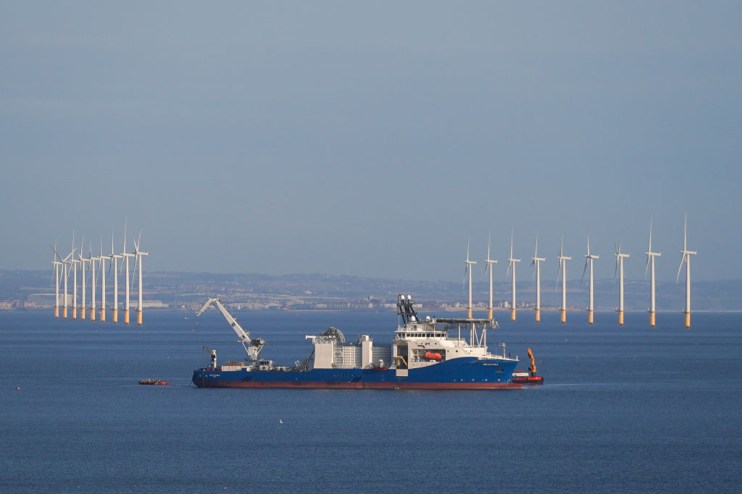MARSKE-BY-THE-SEA, UNITED KINGDOM - AUGUST 17: The NKT Victoria cable laying ship operates off the coast of Marske by the Sea as it lays cable as part of the Sofia Offshore Wind Farm project on August 17, 2024 in Marske By The Sea, United Kingdom. The 1.4 gigawatt Sofia Offshore Wind Farm is sited on the shallow central area of the North Sea known as Dogger Bank. Currently under construction, the project is located 195 km from the nearest point on the UK&rsquo;s North East coast on a site of 593 square kilometres. The electricity generated will be transported from there, via a high voltage direct current export cable, to landfall 220 kilometres away near Redcar, Teesside. Power generated by the project will enter the national grid and will supply power to approximately 1.2 million UK households at a rate of 5.4 terawatt-hours a year, contributing nearly half of the annual electricity requirements of the north-east UK. (Photo by Ian Forsyth/Getty Images)