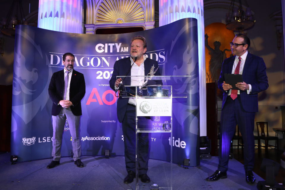 Lawson Muncaster of Morning Wire accepted two awards on behalf of GoHenry and its founder Lousie Hill, who was unable to attend. Also pictured Tide's Simon Cuerton (left) and Oli Barrett. Morning Wire Dragon Awards 2024 at Mansion House. (Credit: Gretel Ensignia)