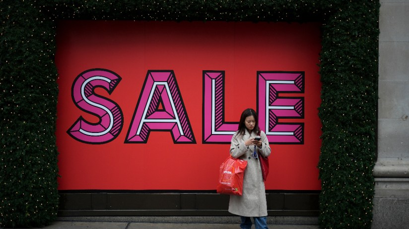 A shopper on Oxford Street, London, during the Boxing Day sales. Photo credit: Jordan Pettitt/PA Wire