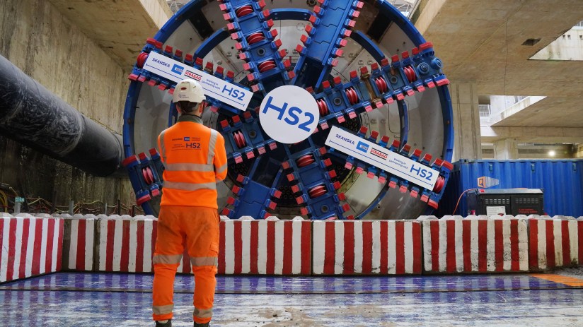 An HS2 worker standing in front of tunnel boring machine Karen at the Old Oak Common station box site during preparations for completing the 4.5 mile HS2 tunnelling to London Euston. HS2 is in a "very serious situation" and needs a "fundamental reset", the new boss of the company building the high-speed railway has warned. Mark Wild, chief executive of HS2 Ltd, said he is committed to ensuring the railway opens "safely and efficiently". Issue date: Monday December 30, 2024. PA Photo. See PA story RAIL HS2. Photo credit should read: Jonathan Brady/PA Wire