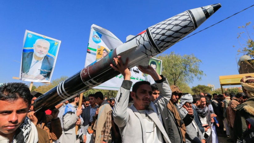 Men carry a mock missile during a rally by university students and faculty denouncing strikes on Yemen and in solidarity with Palestinians, in the Huthi-controlled capital Sanaa on December 25, 2024. Yemen's Huthi rebels said on December 25 that they had fired a ballistic missile at central Israel, with Israeli forces saying they intercepted the attack. (Photo by Mohammed HUWAIS / AFP) (Photo by MOHAMMED HUWAIS/AFP via Getty Images)