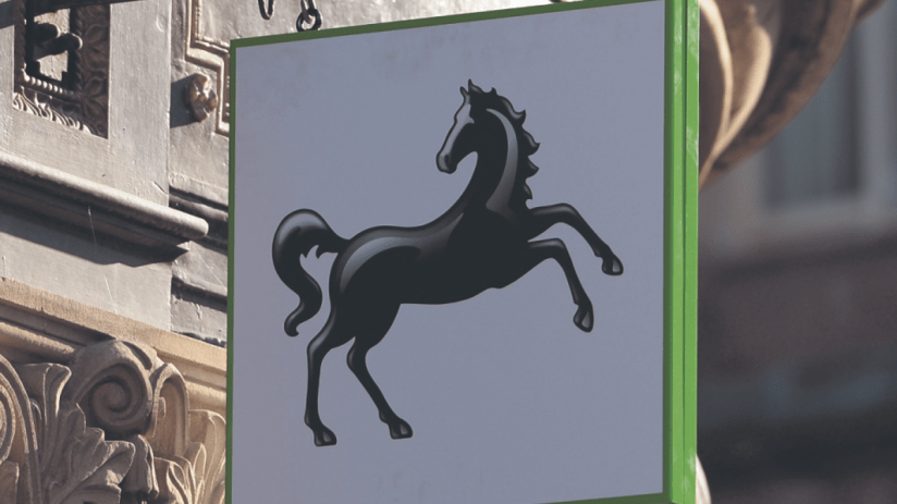 Lloyds Bank exterior with falling stock prices as shares drop on FTSE 100 amid banking sector fears