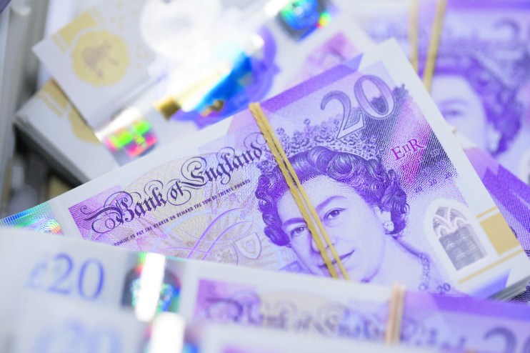 Bundles of new polymer British 20-pound banknotes sit in a basket. De La Rue supplies the Bank of England. Photographer: Jason Alden/Bloomberg via Getty Images