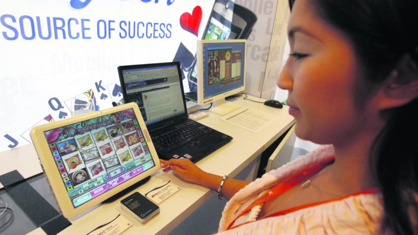 Playtech employee shows the program displayed on the screen for gaming software (ROSLAN RAHMAN/AFP/Getty Images)