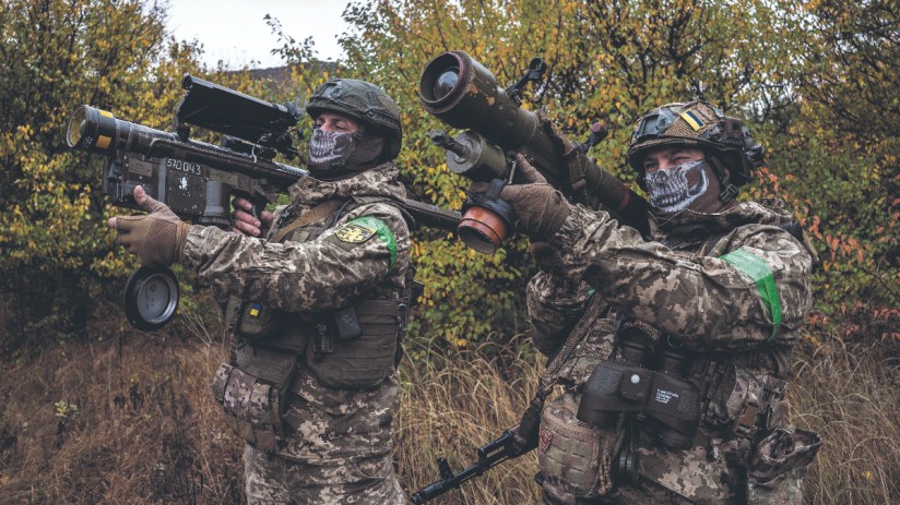 Two Ukrainian soldiers check the scopes of their anti-aircraft systems to ensure they're working properly before heading out on a mission in Donetsk Oblast, Ukraine (Photo by Fermin Torrano/Anadolu via Getty Images)