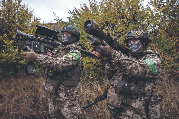 Two Ukrainian soldiers check the scopes of their anti-aircraft systems to ensure they're working properly before heading out on a mission in Donetsk Oblast, Ukraine (Photo by Fermin Torrano/Anadolu via Getty Images)