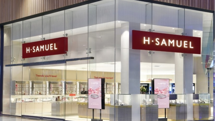 The company behind H Samuel and Ernest Jones has cut its pre-tax loss.