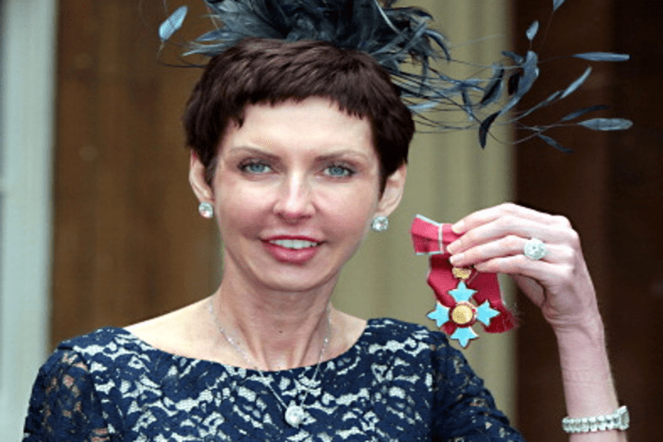 Bet365 chief executive Denise Coates poses with her CBE medal at Buckingham Palace on May 15, 2012. (Photo by Sean Dempsey &ndash; WPA Pool/Getty Images)