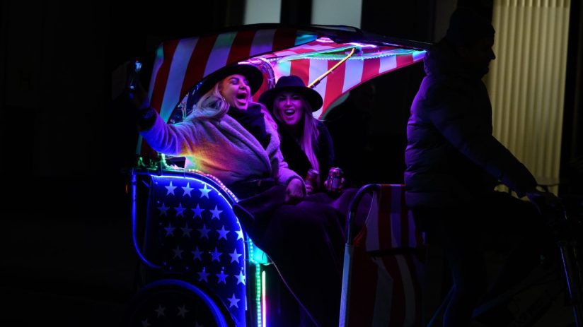 LONDON, UNITED KINGDOM - DECEMBER 06: Two women sing aloud to the onboard stereo system as they're transported through Westminster on a pedicab on December 06, 2023 in London, United Kingdom. (Photo by Leon Neal/Getty Images)