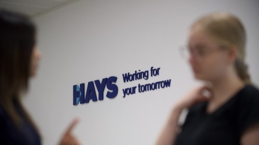 Hays office building with fluctuating stock graph overlay, representing the impact of selling operations in six countries