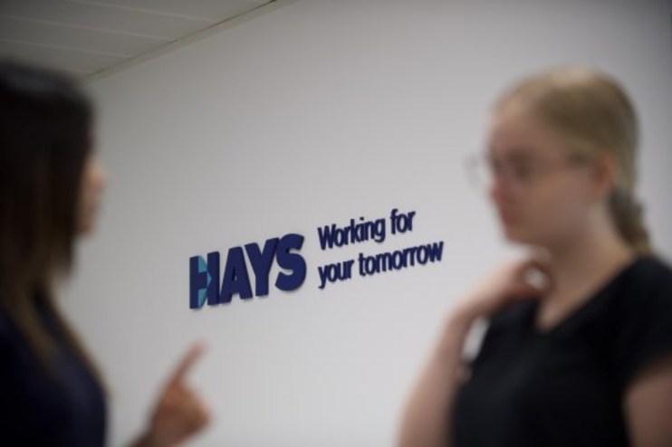 Hays office building with fluctuating stock graph overlay, representing the impact of selling operations in six countries