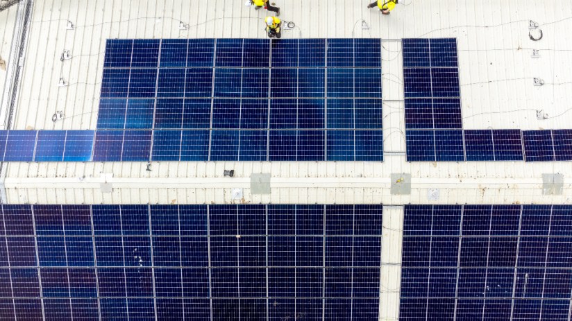Good Energy workers installing commercial solar panels.