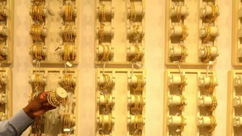Gold jewelry displayed in Indian market as gold price hits record $5,097 amid Trump tariff turmoil and investor demand