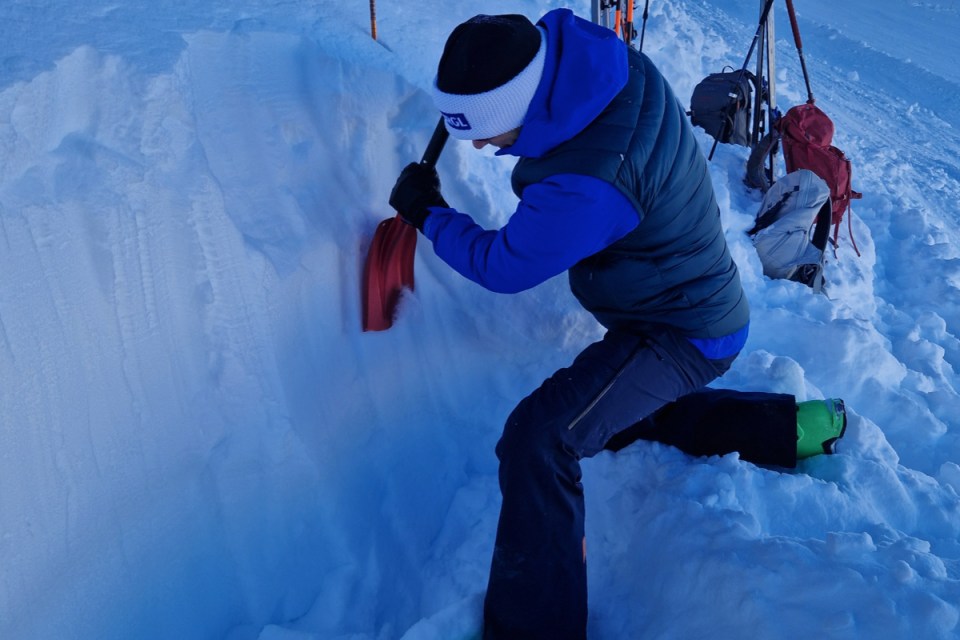 Simon Miller digs a hole in his avalanche training