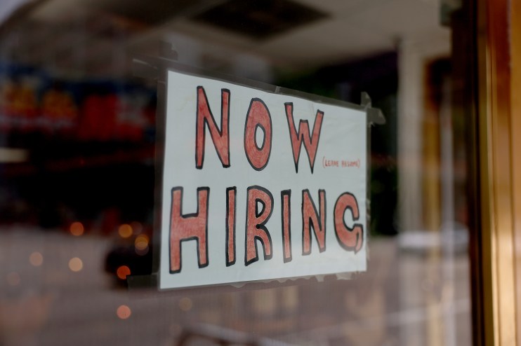 MIAMI, FLORIDA - MAY 05: A 'Now Hiring' sign posted on the window of a business looking to hire workers on May 05, 2023 in Miami, Florida. A report by the Bureau of Labor Statistics showed the US economy added 253,000 jobs in April. (Photo by Joe Raedle/Getty Images)