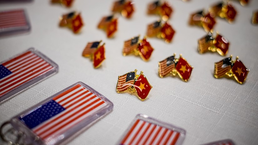HO CHI MINH CITY, VIETNAM - NOVEMBER 09: American and Vietnamese flag pins are gave away at the live election results watch party hosted by the United States Consulate General at a convention center on November 9, 2016 in Ho Chi Minh City, Vietnam. Donald Trump's stunning performance in the US presidential election triggered shock and angst in Asia, where observers fretted over the implications for everything from trade to human rights and climate change. (Photo by Linh Pham/Getty Images)