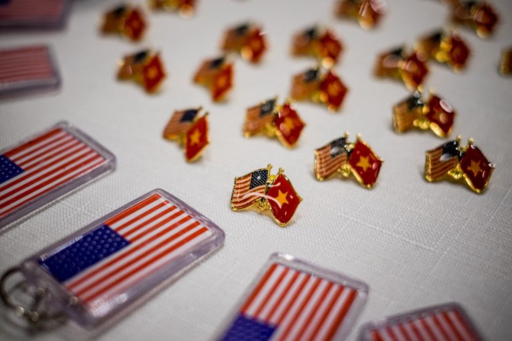 HO CHI MINH CITY, VIETNAM - NOVEMBER 09: American and Vietnamese flag pins are gave away at the live election results watch party hosted by the United States Consulate General at a convention center on November 9, 2016 in Ho Chi Minh City, Vietnam. Donald Trump's stunning performance in the US presidential election triggered shock and angst in Asia, where observers fretted over the implications for everything from trade to human rights and climate change. (Photo by Linh Pham/Getty Images)