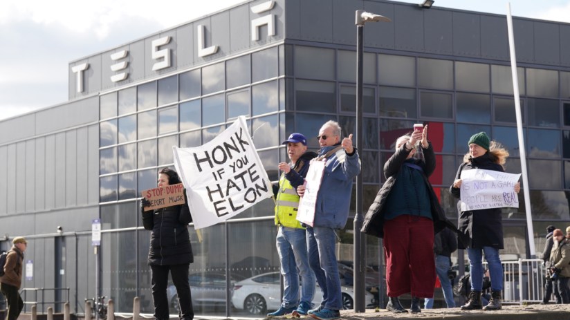 Protesters gathered outside a Tesla dealership in London have called for people to boycott the Elon Musk owned electric car maker. Photo: PA
