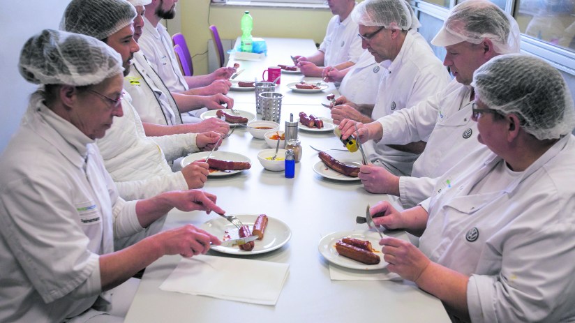 Members of the production team eat currywurst sausages during the daily 10:00am tasting session in the Volkswagen AG (VW) manufacturing plant in Wolfsburg, Germany, on Thursday, March 12, 2020. This week VW made its highest employee bonus payment since 2015, the automaker's works council said in a staff newsletter. Photographer: Krisztian Bocsi/Bloomberg via Getty Images