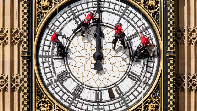 LONDON, ENGLAND - AUGUST 19: Workers clean the East-facing clock face of the Elizabeth Tower of the Houses of Parliament on August 19, 2014 in London, England. Workers are cleaning the four faces of the Great Clock, some 60 meters above ground, which contains the Big Ben bell.