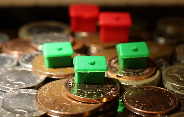MANCHESTER, UNITED KINGDOM - OCTOBER 24: In this photo illustration, houses from a Monopoly board game sit on top of British currency coins on October 24, 2008 in Manchester, England. As markets across the globe continue to struggle the world wide credit crunch begins to bite deeper with fears of economic recession (Photo by Christopher Furlong/Getty Images)